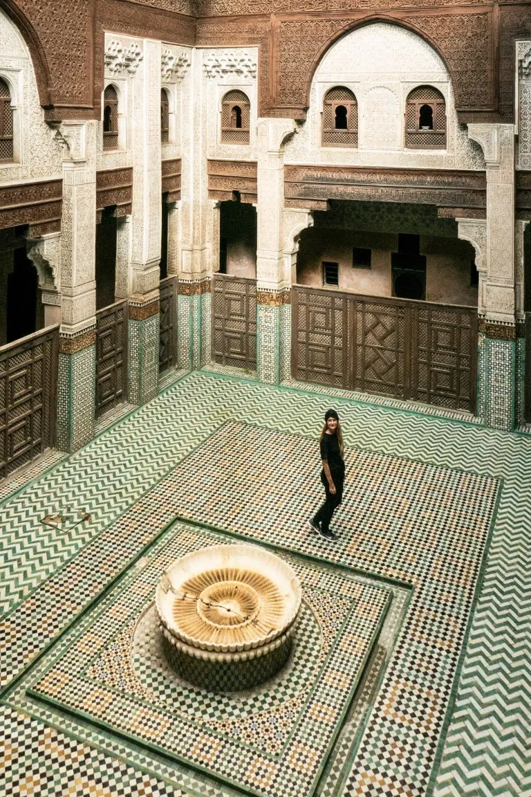Exploring a historic medersa courtyard while planning a Morocco itinerary